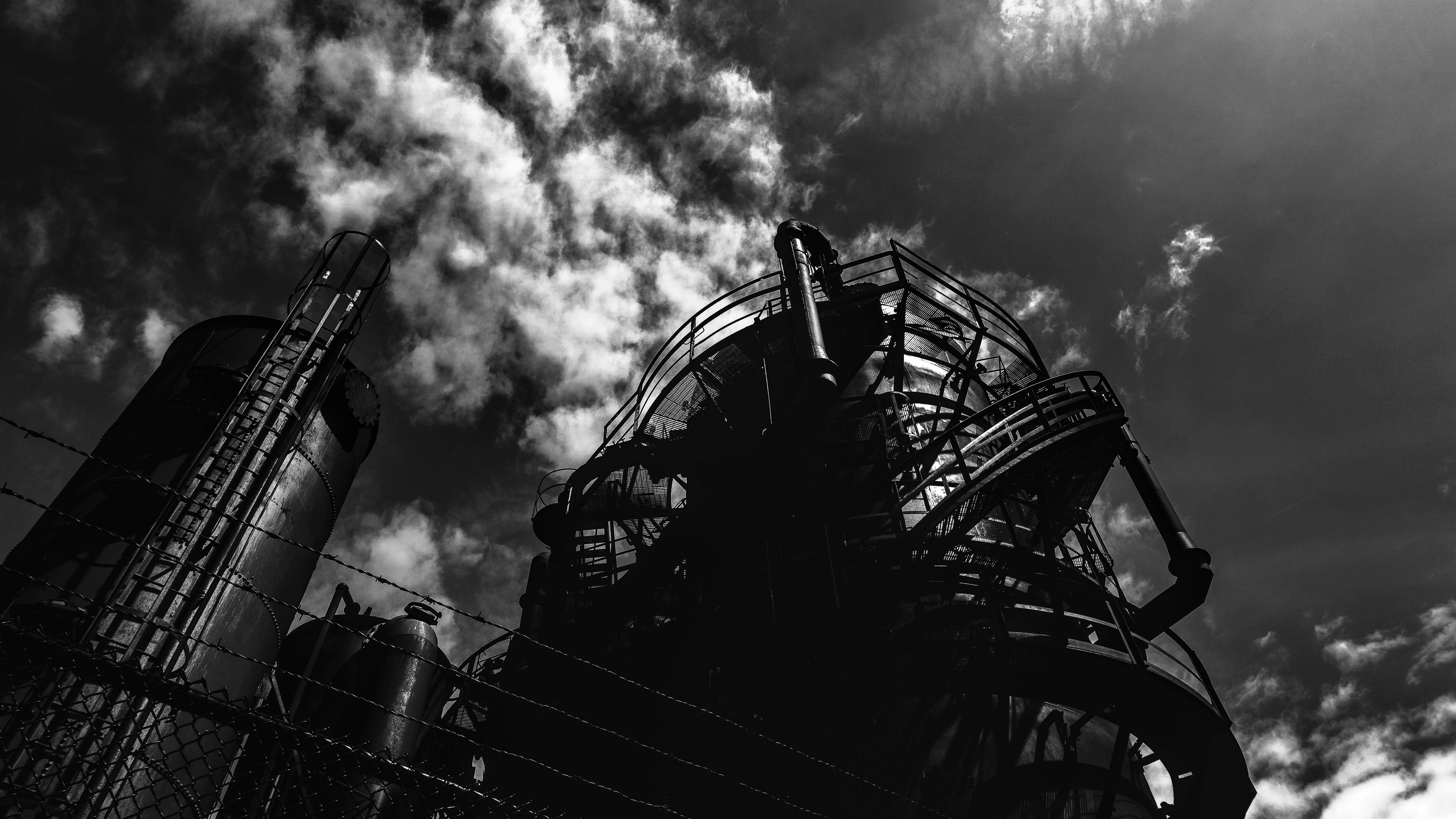 grayscale photo of ferris wheel under cloudy sky